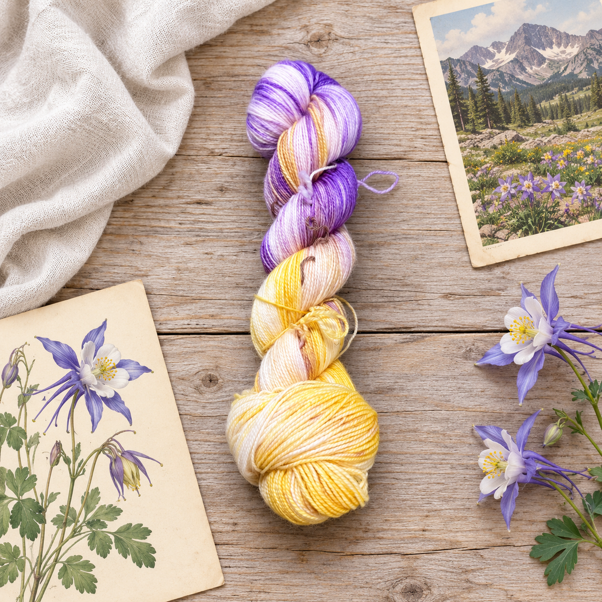 Columbine hand-dyed yarn in violet, lavender, ivory, and yellow on weathered wood with columbine flowers, a botanical illustration, and a mountain print.