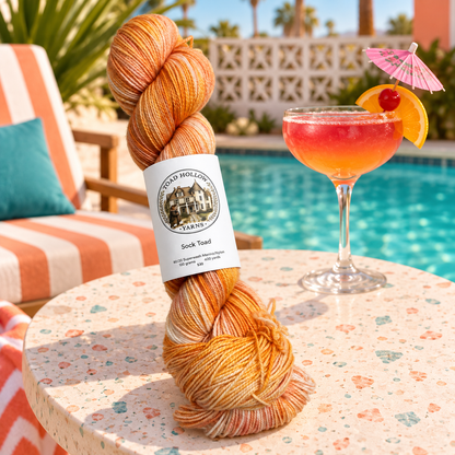 a stylized photo of umbrella drinks and orange and pink variegated yarn from toad hollow.
