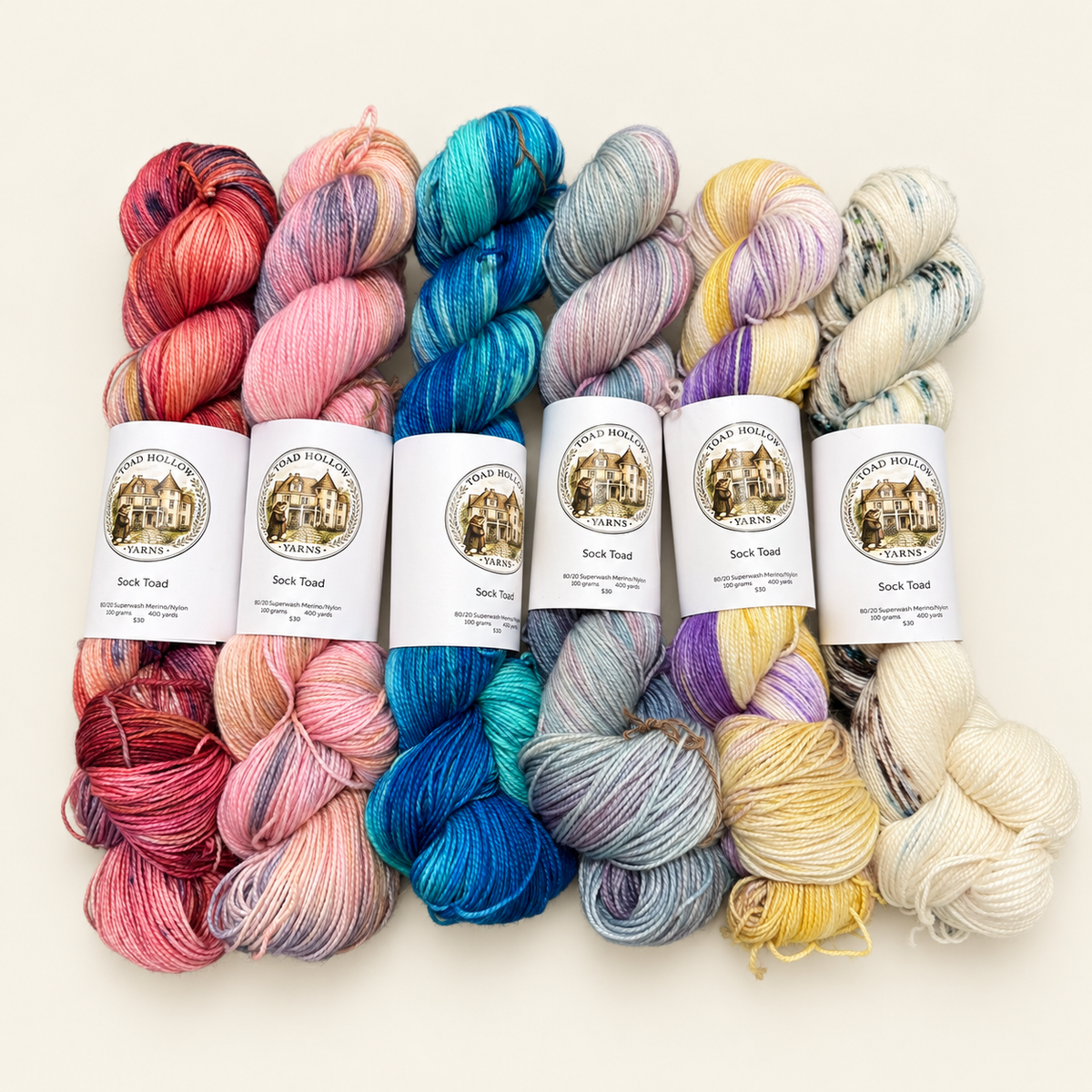 COLUMBINE Hand-dyed yarn - Cream, Purple & Yellow variegated yarn from the Road Trip Collection|Fingering, DK, Worsted, and Bulky Superwash Merino yarn| Toad Hollow Yarns